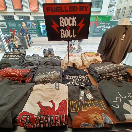 Display tables of t-shirts were themed by subjects such as rock n roll.
